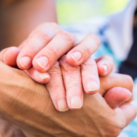 Holding hands Senior and caregiver holding hands